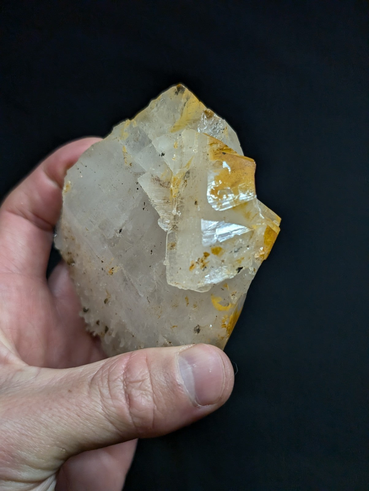 A translucent, crystalline mineral specimen with a mix of clear and golden-yellow hues.