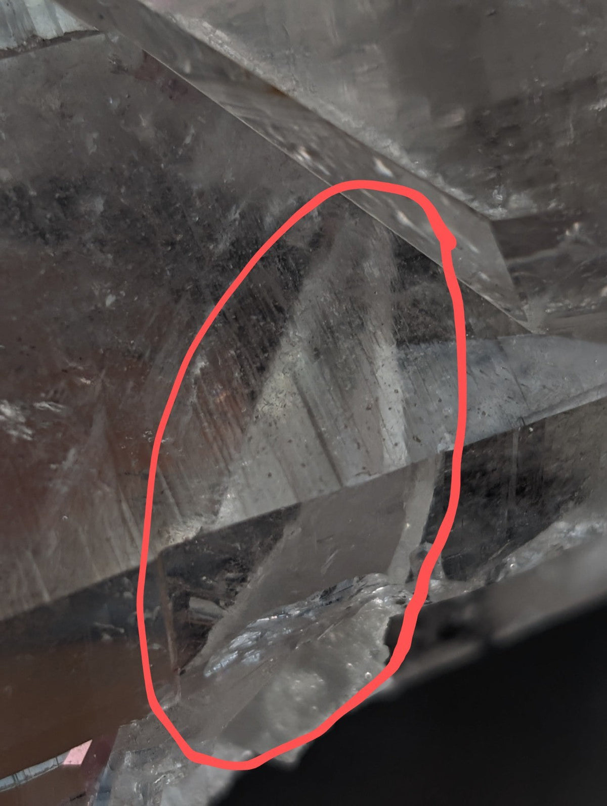 A translucent, faceted quartz crystal with a clear and slightly cloudy appearance.