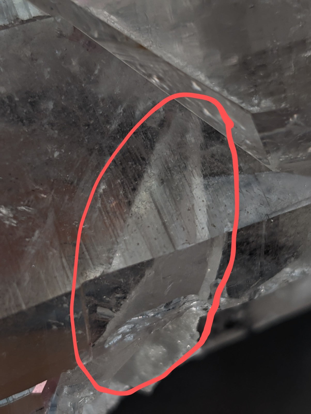A translucent, faceted quartz crystal with a clear and slightly cloudy appearance.