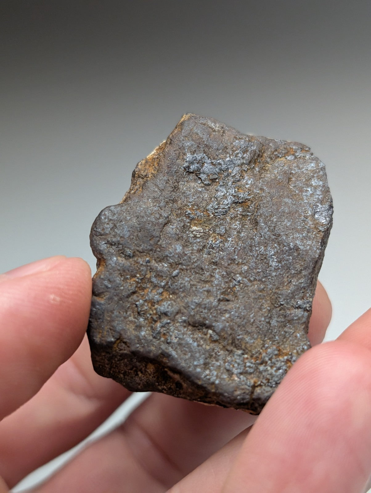 A rugged magnetite lodestone from magnet cove arkansas with dark metallic surface and rust-colored oxidation patches