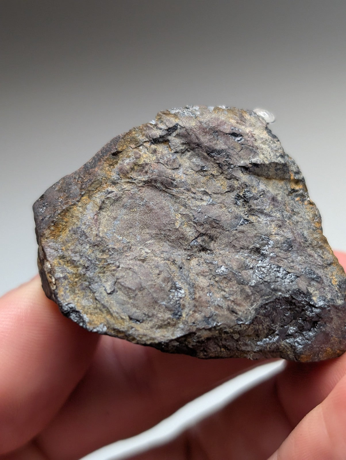Magnetite lodestone meteorite from magnet cove arkansas with dark gray surface yellowish brown streaks and metallic sheen