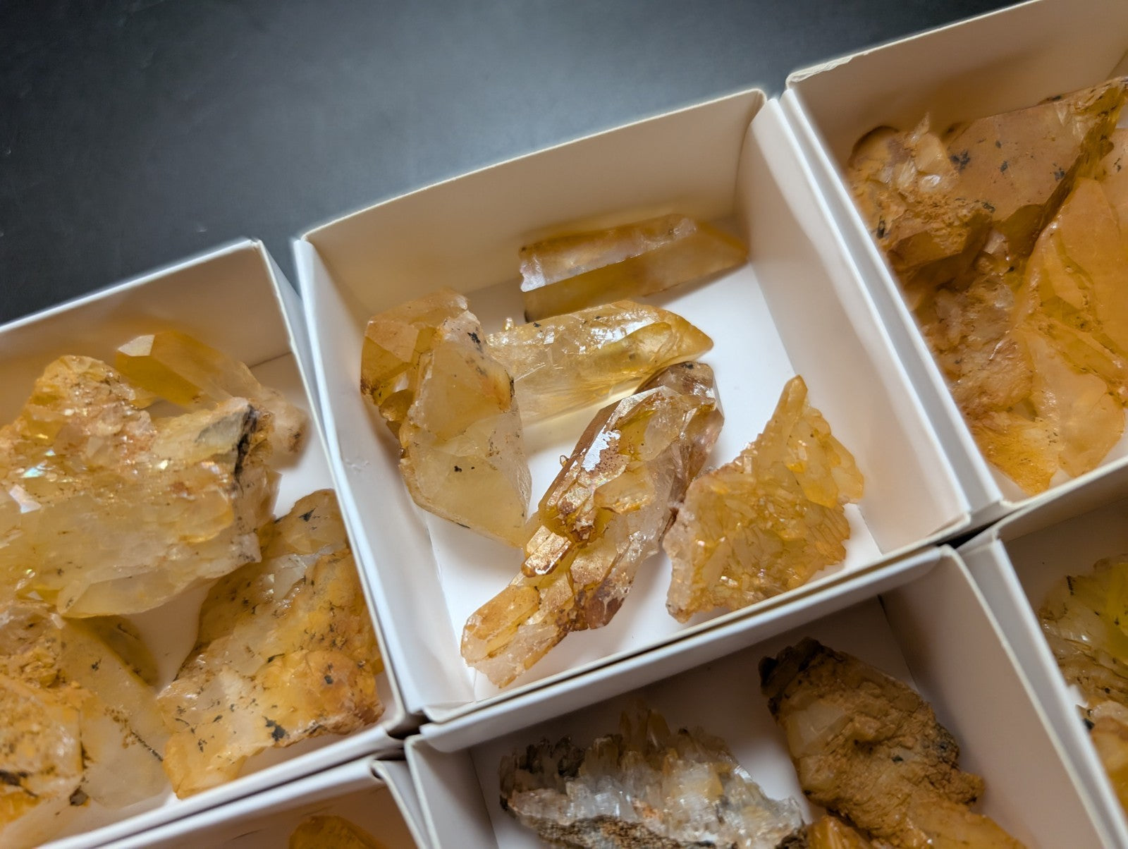 Golden calcite specimens in boxes.