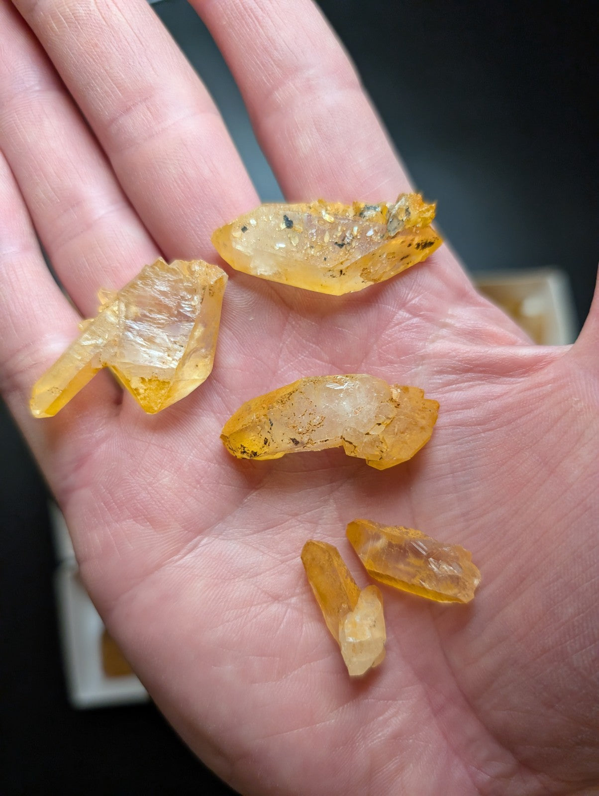 Yellow translucent citrine crystals with natural facets and inclusions.