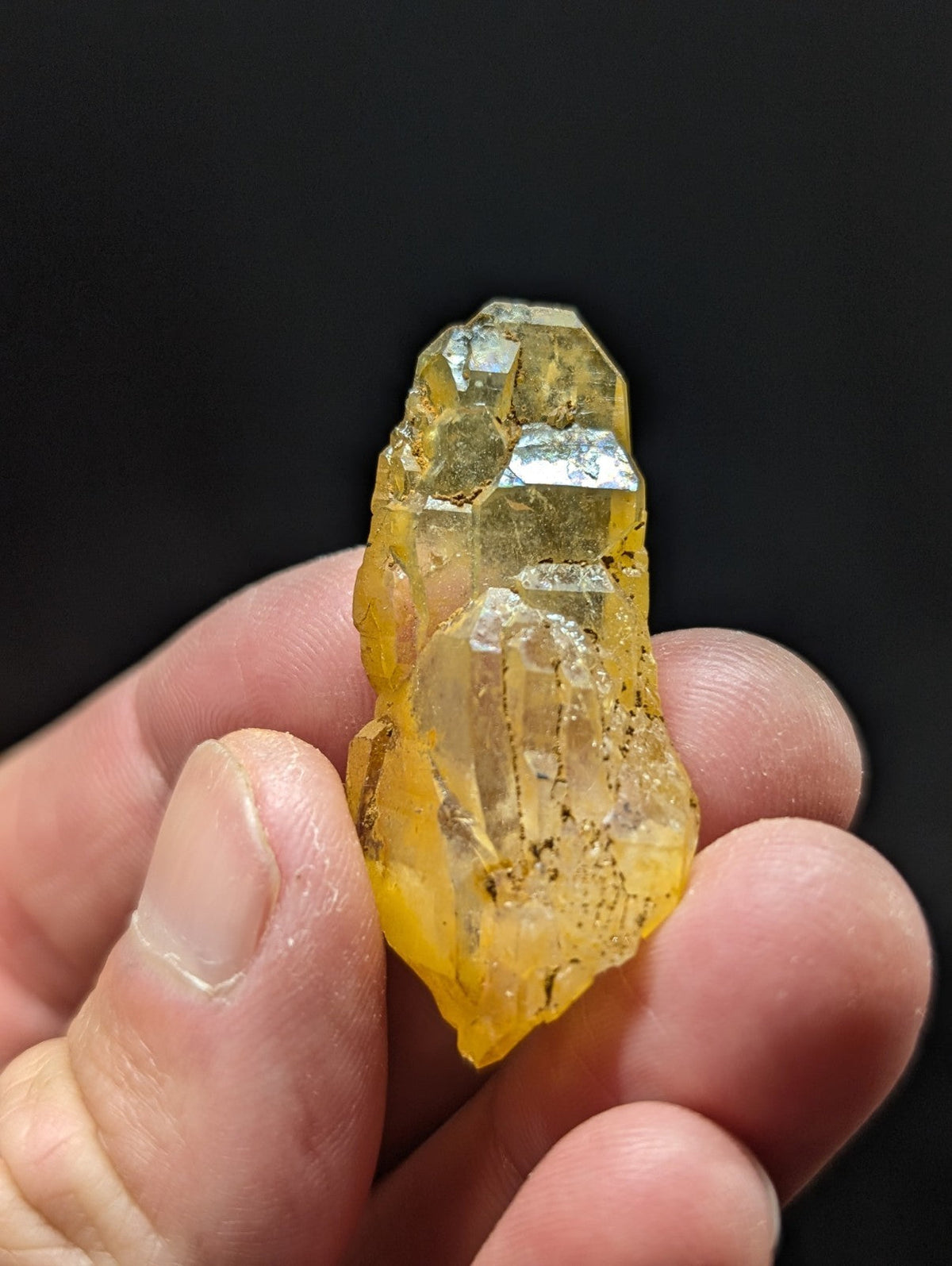 A translucent yellow crystal with clear, faceted sections and subtle internal inclusions.