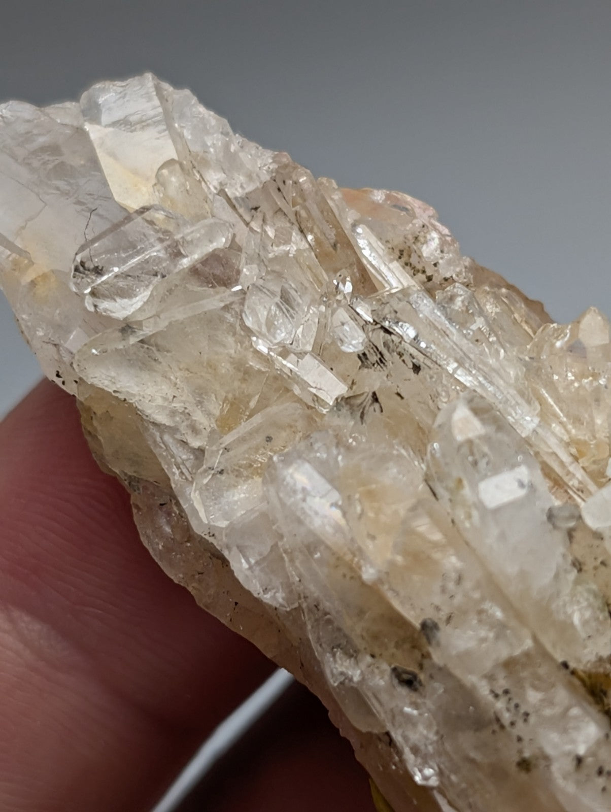 Parallel growth quartz crystal cluster with translucent pale yellow facets and rough earthy base from saline county arkansas usa