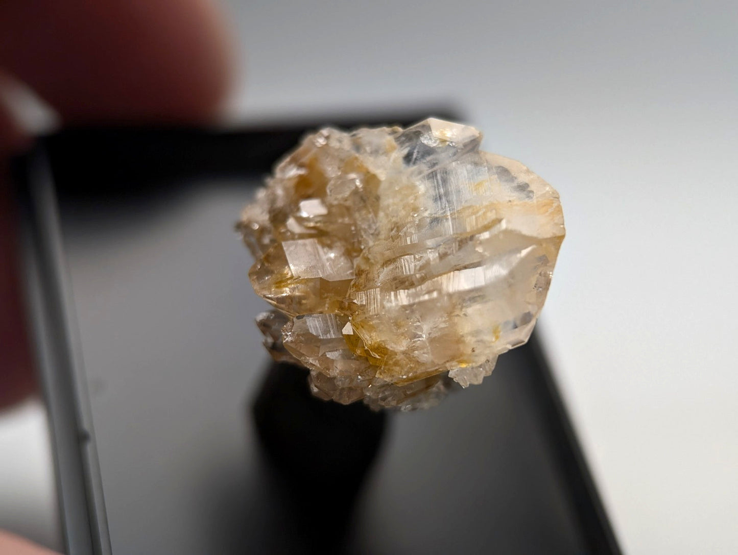 A translucent yellowish crystal cluster with clear, faceted surfaces and a rough, natural texture.