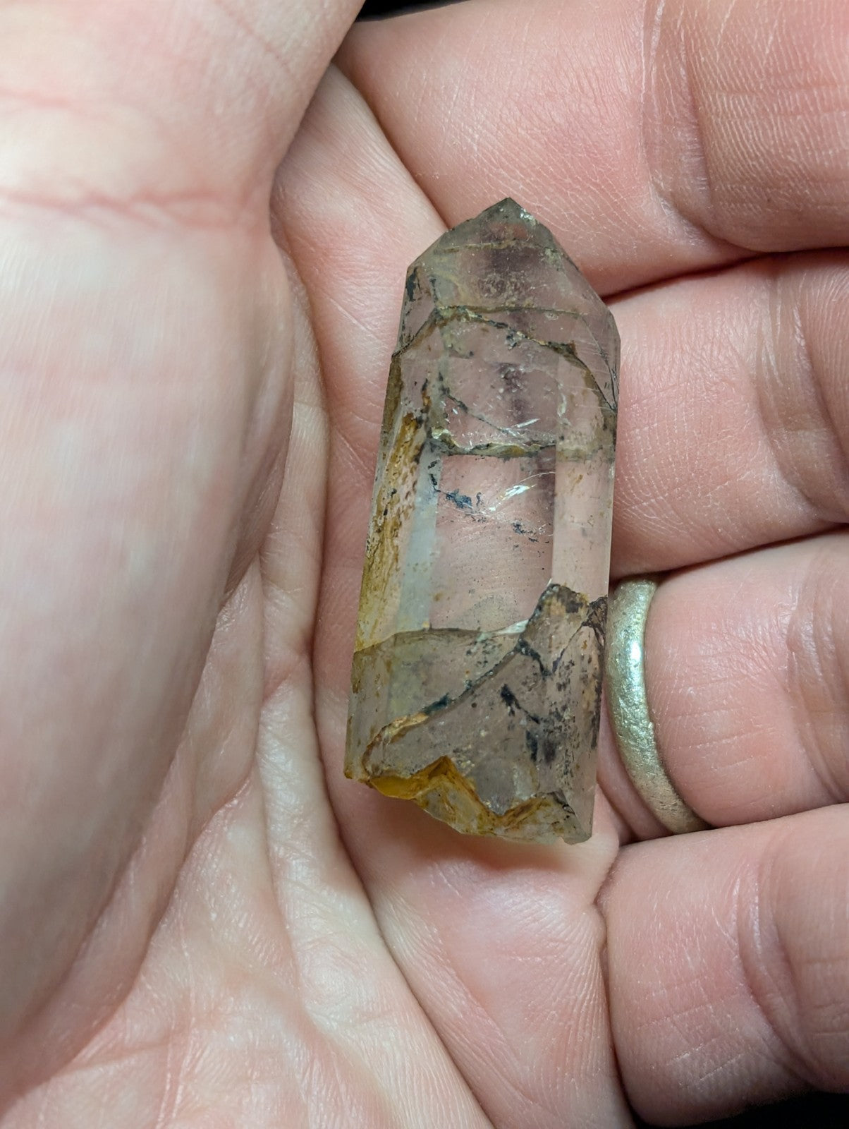 A translucent, faceted quartz crystal with natural inclusions and a gradient of clear to golden hues.