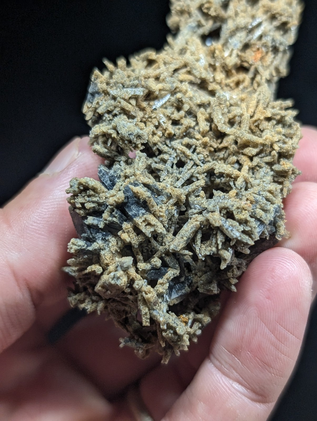 A textured, branching mineral specimen with a mix of earthy brown and gray hues.