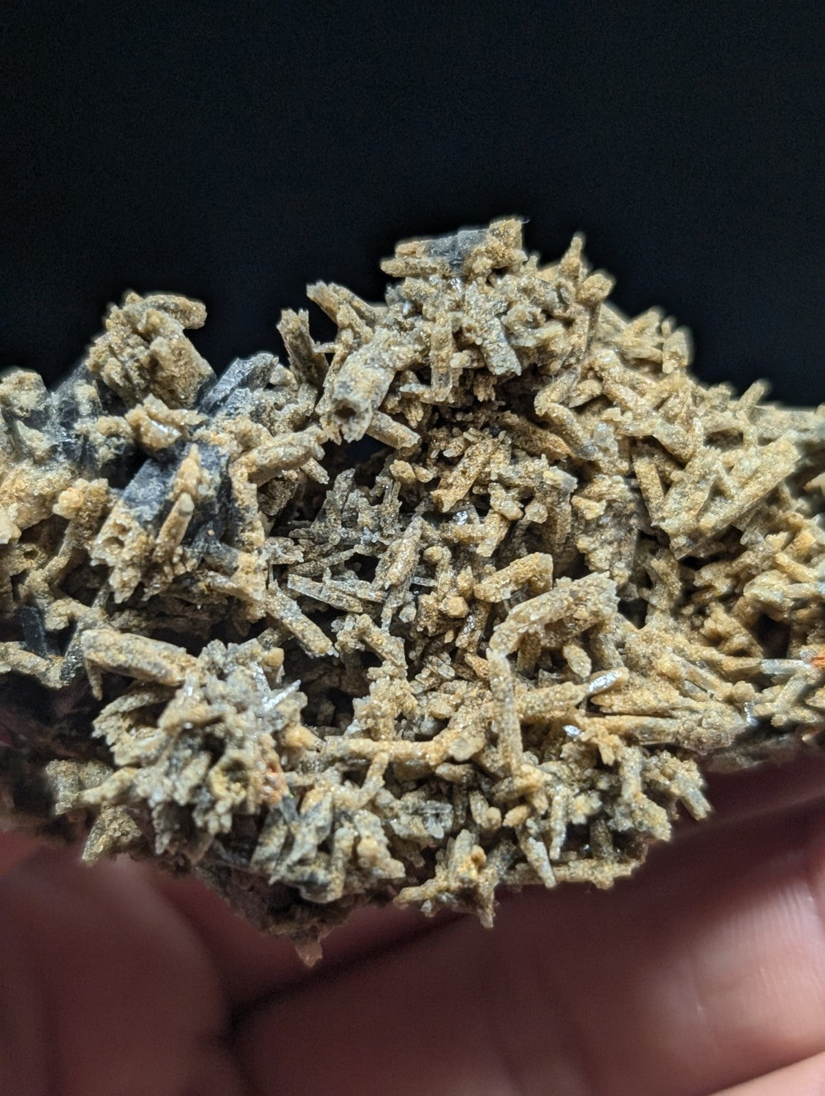 A cluster of earthy brown and gray mineral crystals with a rough, textured surface.