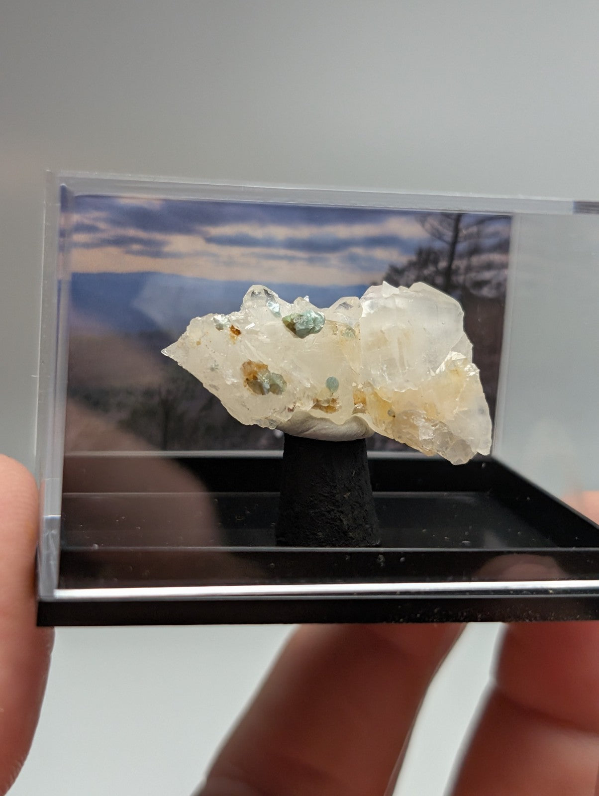 Quartz crystal cluster with blue-green cookeite translucent white mineral with green and yellow specks in clear acrylic case