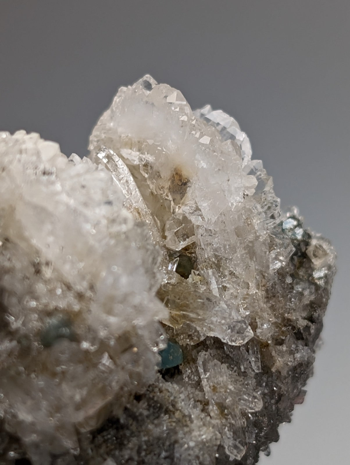 Quartz crystal cluster with blue green cookeite from Saline County Arkansas featuring translucent white facets and subtle inclusions