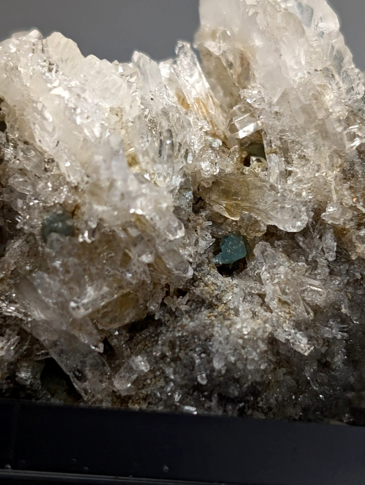 Quartz crystal cluster with blue-green cookeite from Saline County Arkansas showing translucent pale yellow facets