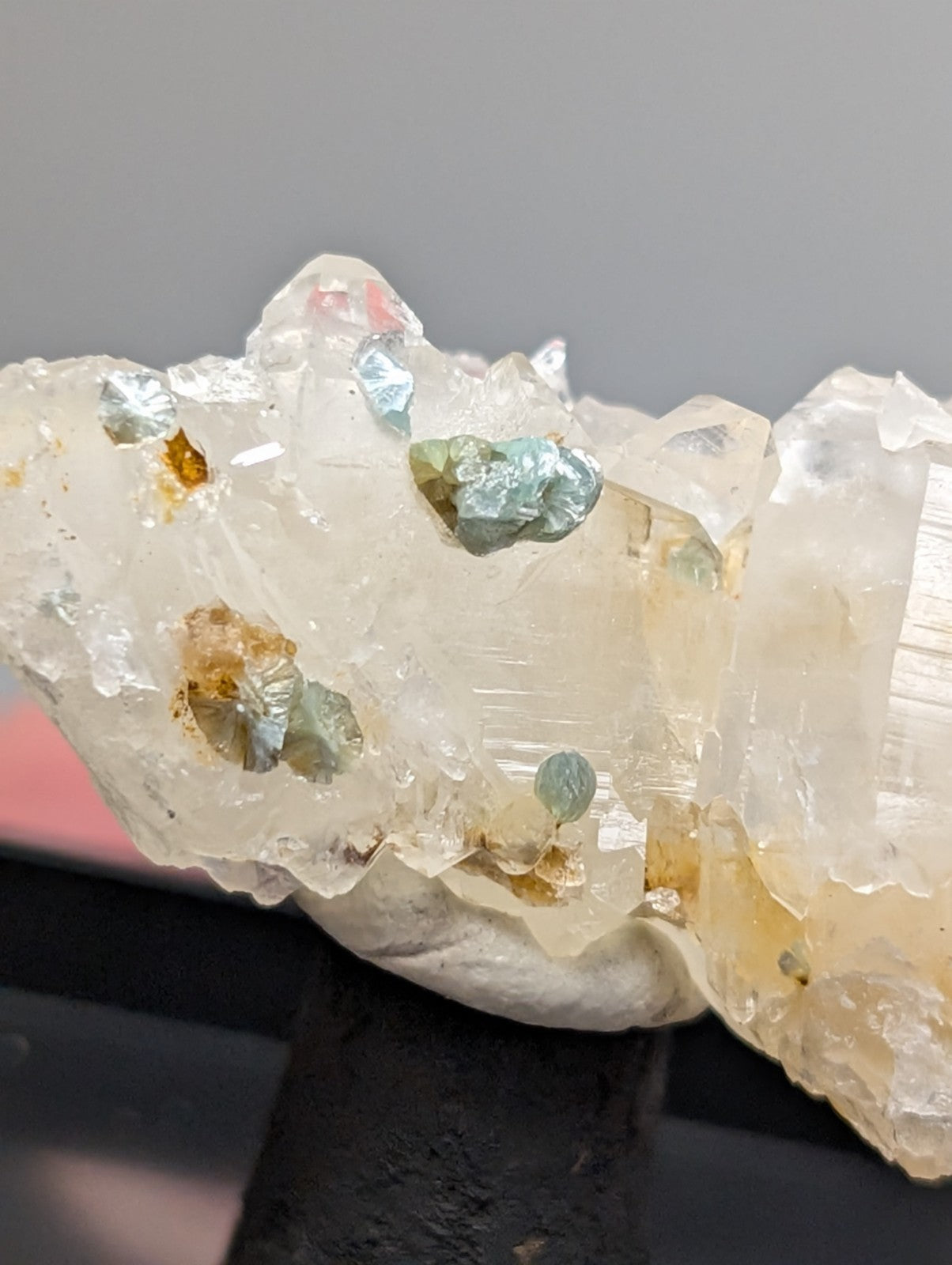Quartz crystal cluster with blue-green cookeite and golden-brown specks from saline county arkansas under uv light