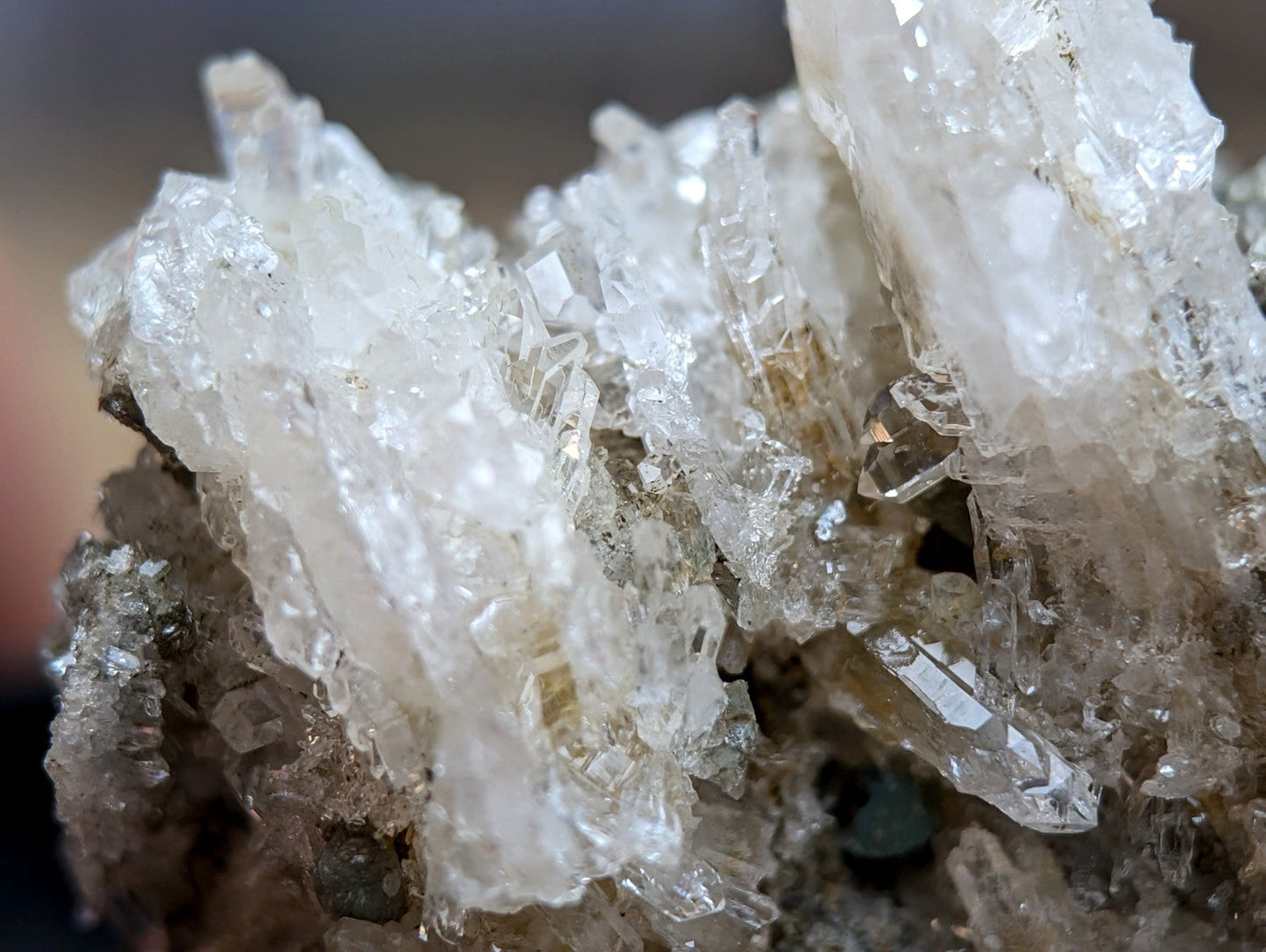 Quartz crystal cluster with blue-green cookeite from Saline County Arkansas showing translucent faceted formations under UV light