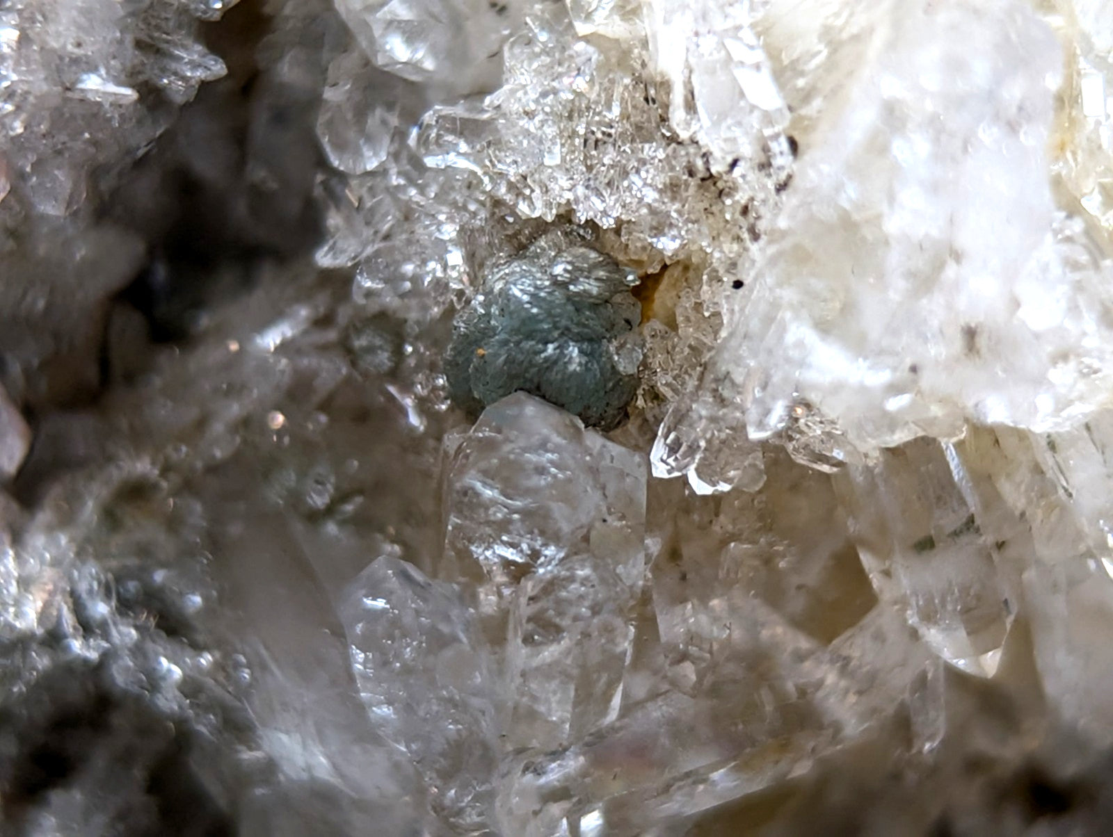 Quartz crystal cluster with blue-green cookeite nestled among translucent white quartz from saline county arkansas