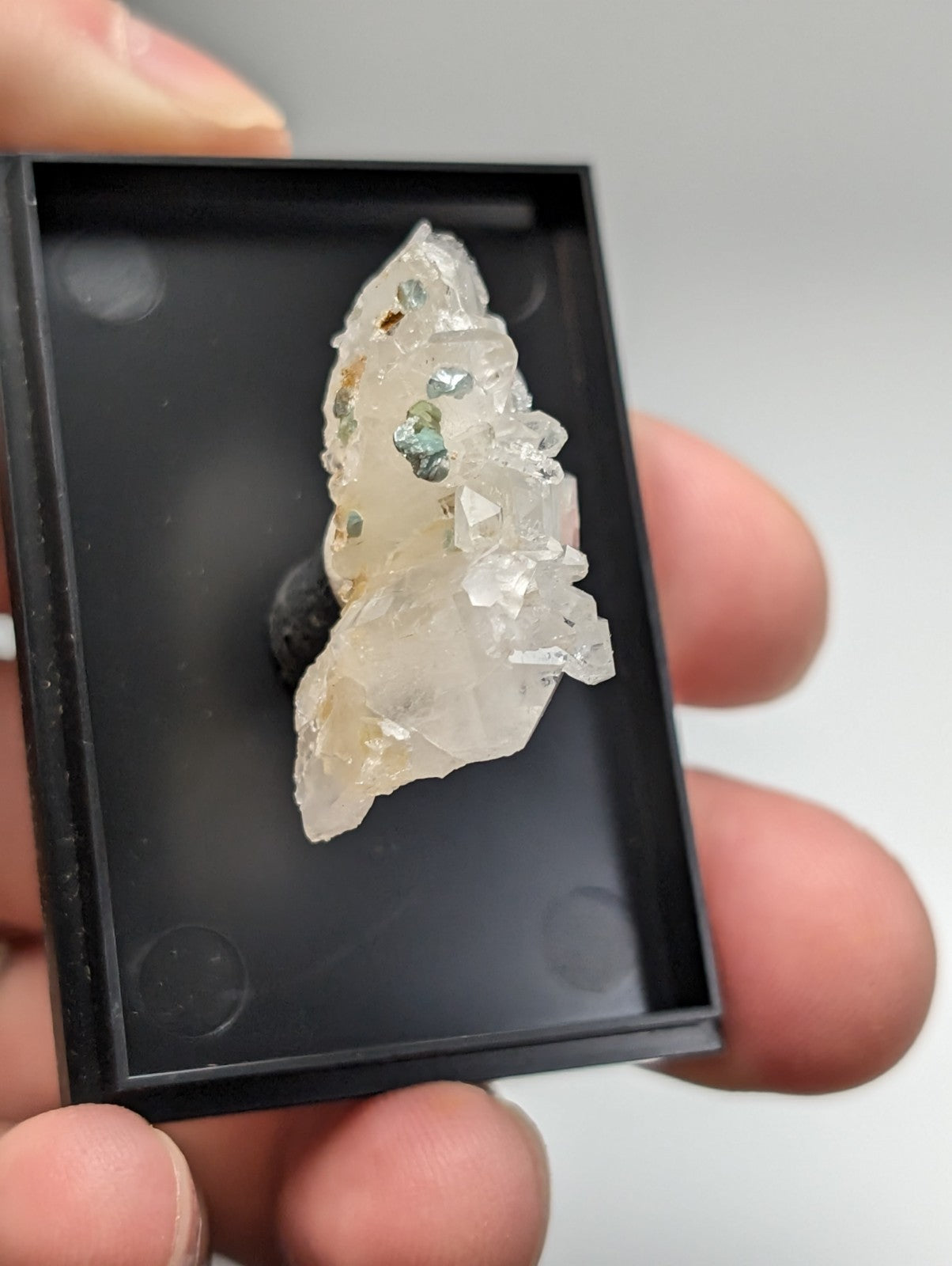 Translucent quartz crystal cluster with blue-green cookeite and jagged faceted surface from saline county arkansas