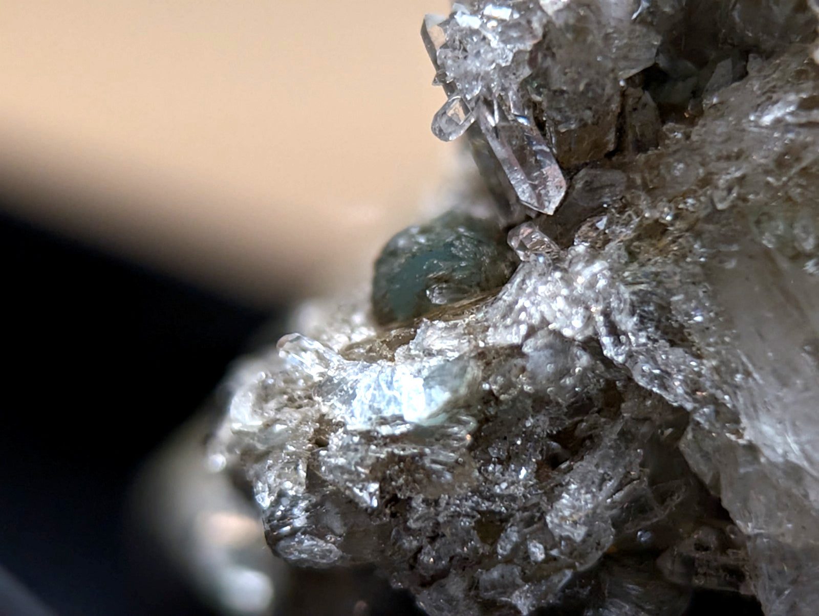 A quartz crystal cluster with a translucent blue-green cookeite gemstone from saline county arkansas under uv light