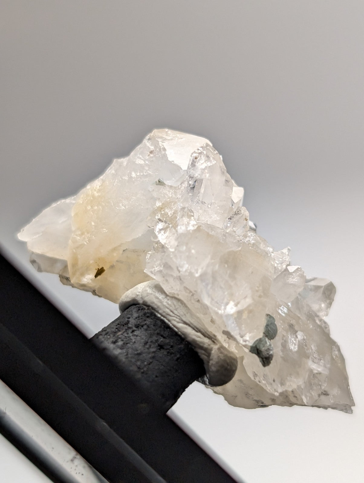 A clear quartz crystal cluster with blue-green cookeite from saline county arkansas featuring a yellowish tint