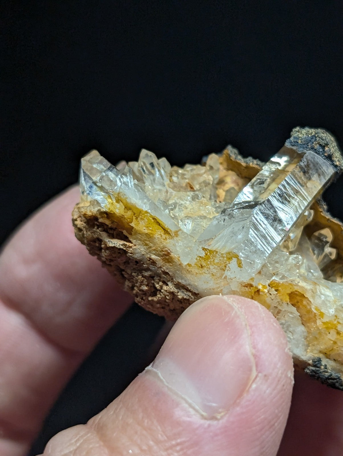 A translucent, crystalline quartz cluster with sharp facets and a golden-yellow matrix.