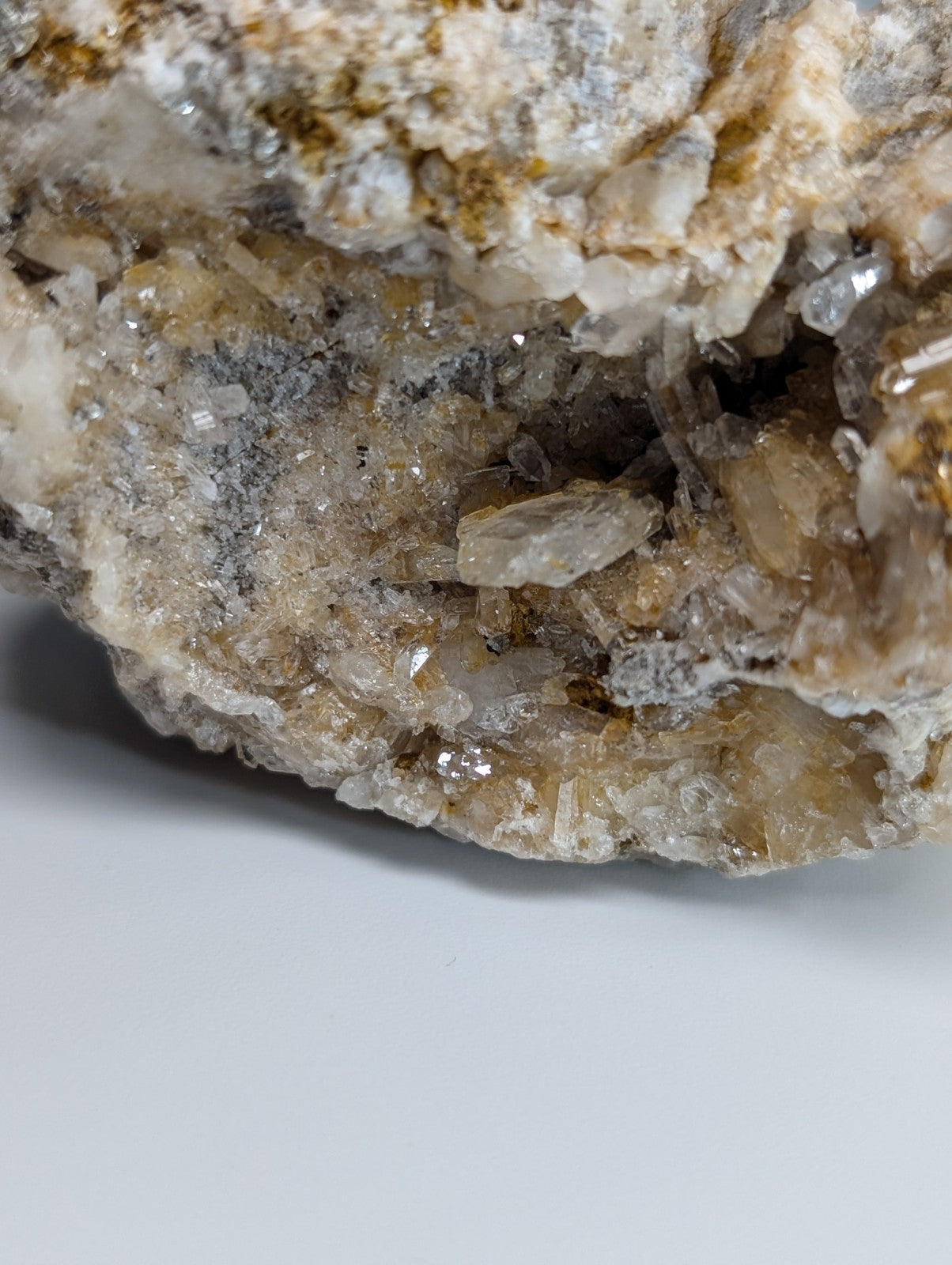 Quartz crystal cluster with solution quartz and cookeite in clear and golden-brown hues on gray matrix from Arkansas