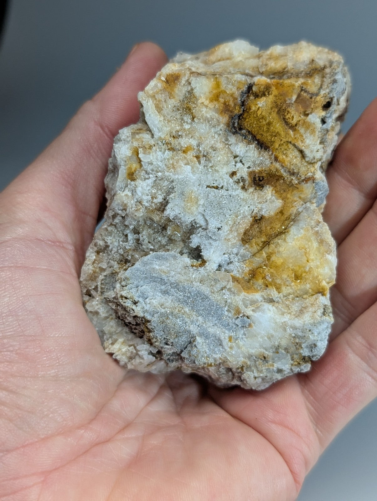 Quartz crystal cluster with solution quartz and cookeite featuring a mottled white gray and golden-yellow surface from Arkansas