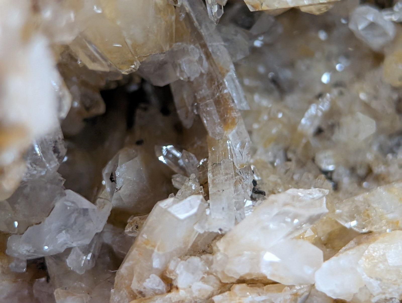 A cluster of translucent quartz crystals with clear and milky white solution quartz and cookeite from Arkansas