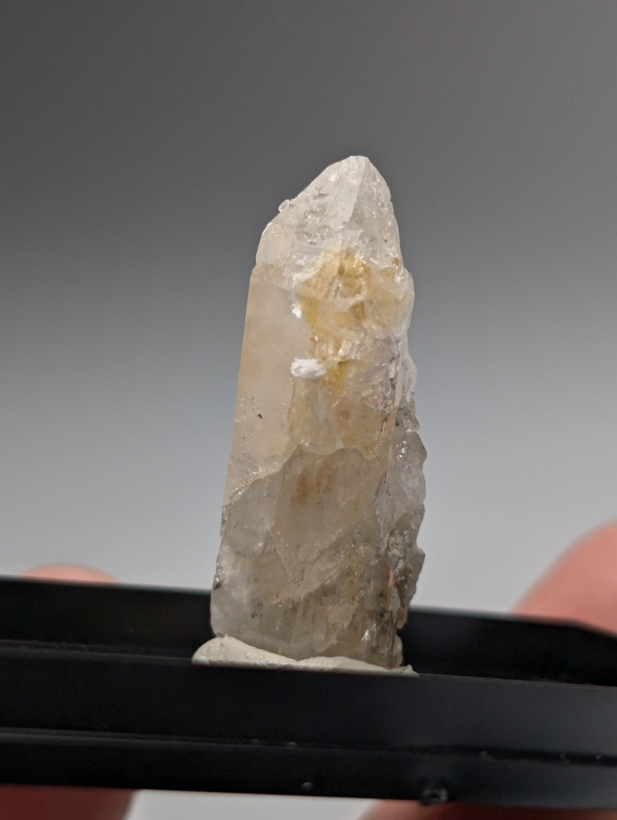 Quartz crystal point translucent pale yellowish with UV reactive cookeite natural facets from Saline County Arkansas USA