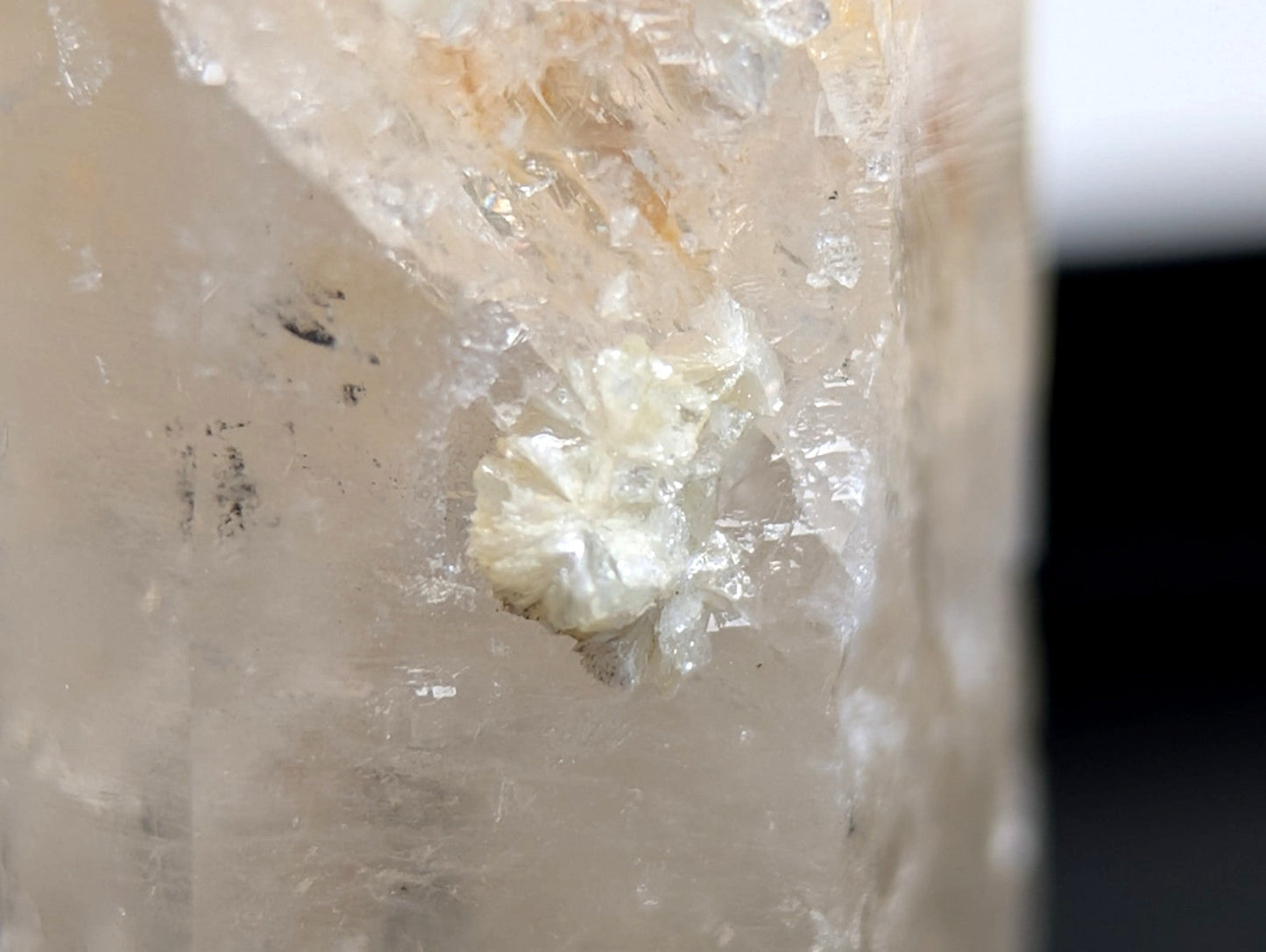 Quartz crystal point with a translucent pale formation and delicate flower-like uv reactive cookeite cluster from Arkansas