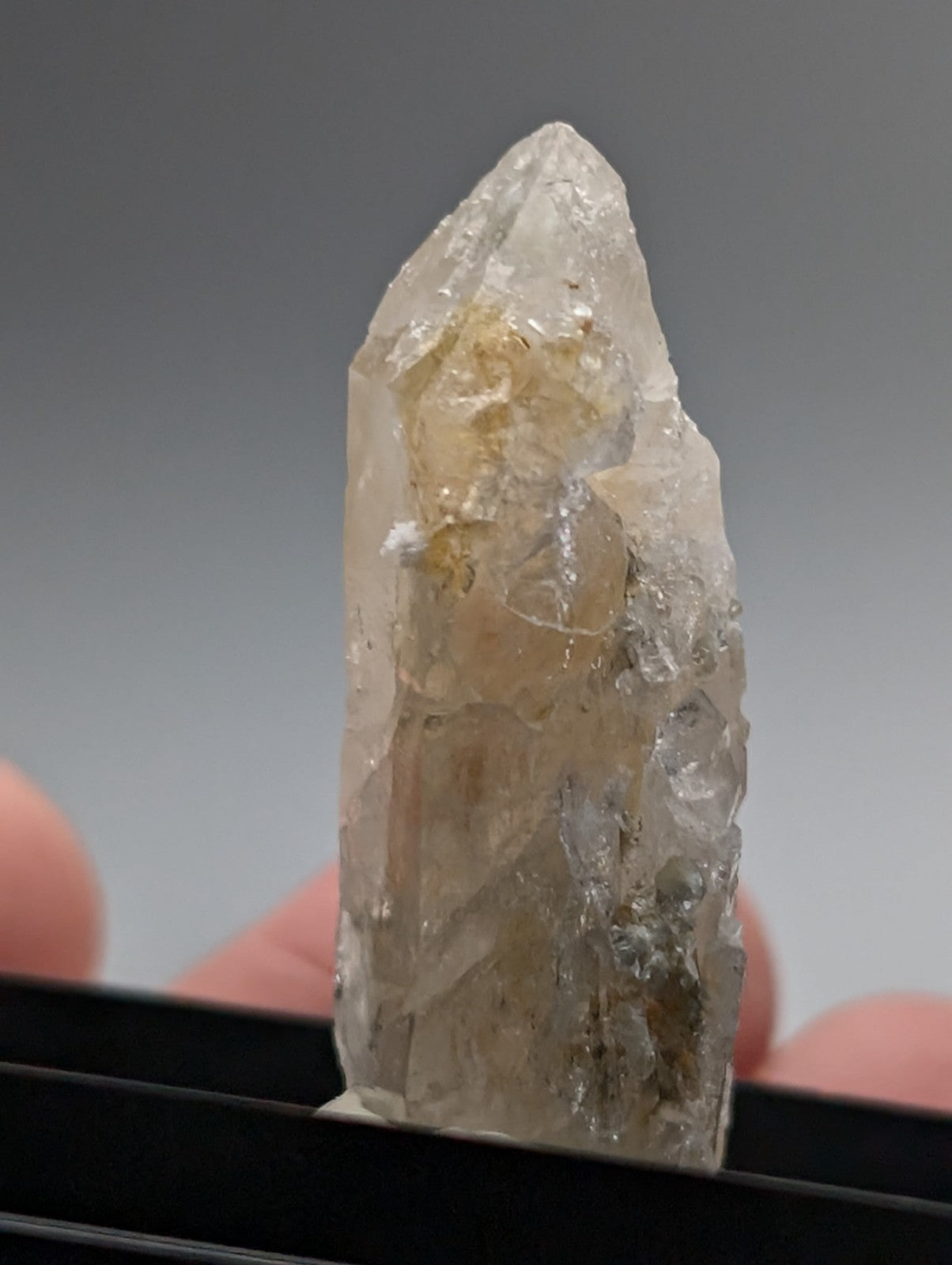 Quartz crystal point with translucent pale yellow quartz and UV reactive cookeite from Saline County Arkansas USA