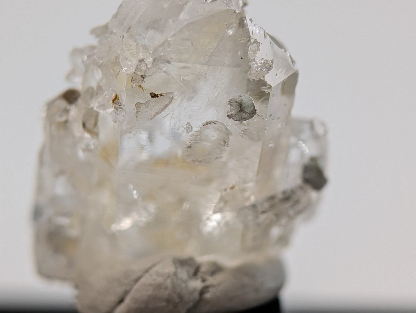 A translucent, clear quartz crystal cluster with natural facets and subtle internal inclusions.