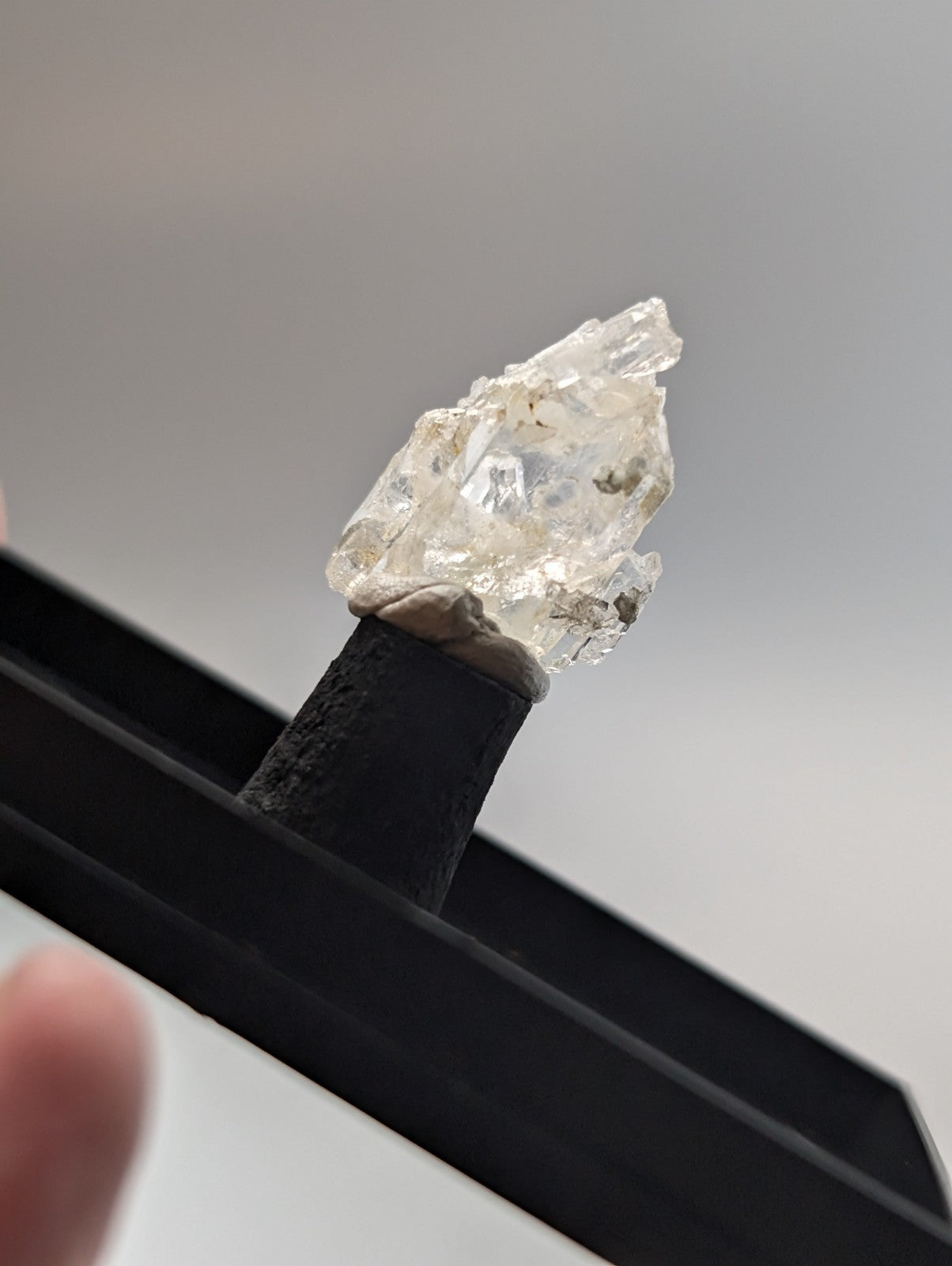 A raw, translucent white diamond crystal with natural facets and inclusions.