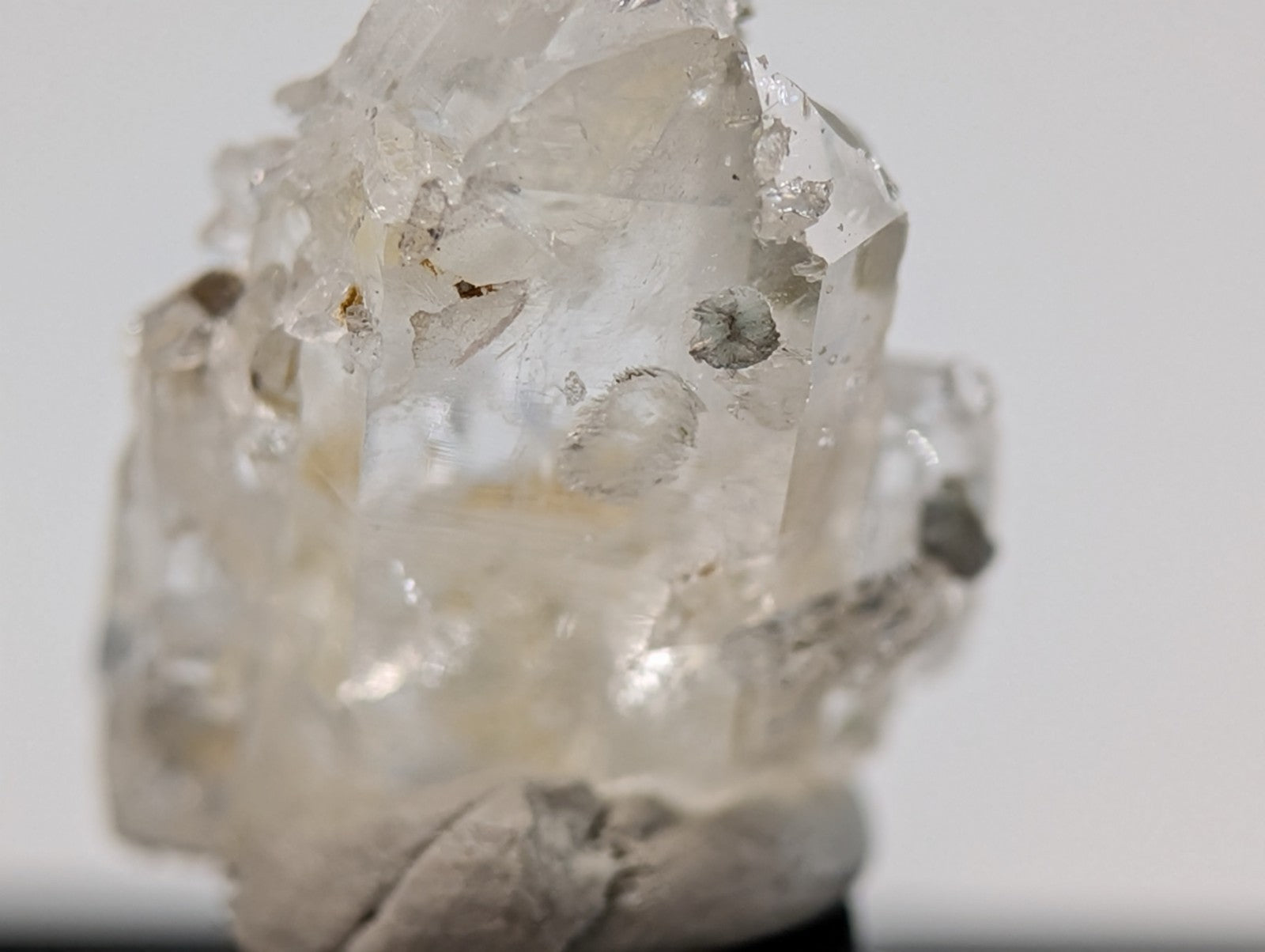 A translucent, clear quartz crystal cluster with natural facets and subtle internal inclusions.