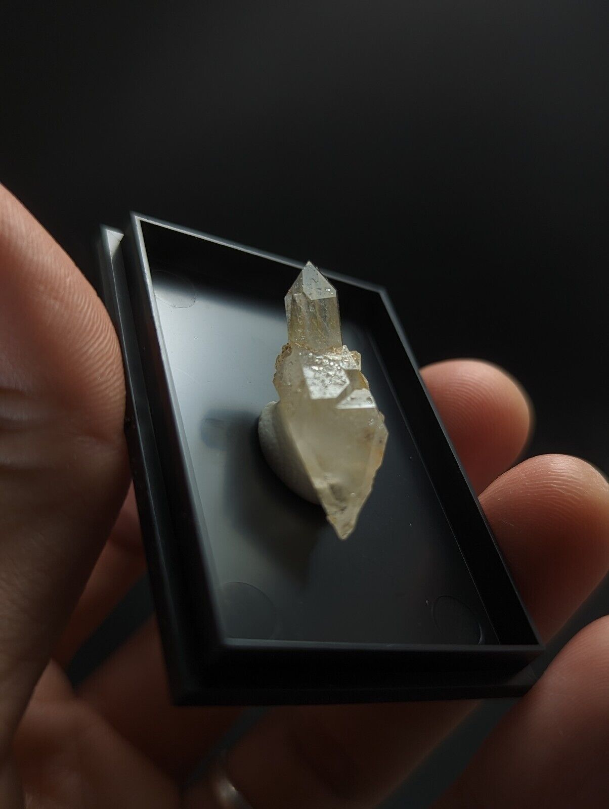 Translucent crystal specimen in a black display box.