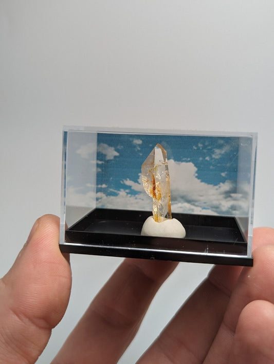 Quartz crystal specimen in display case.