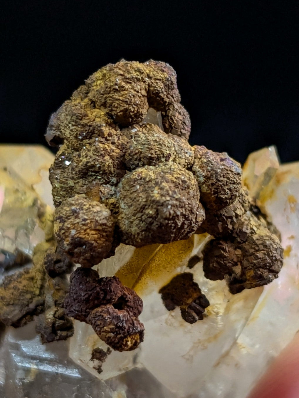 A rugged, earthy-toned mineral specimen with rounded, clustered formations and a rough, textured surface.