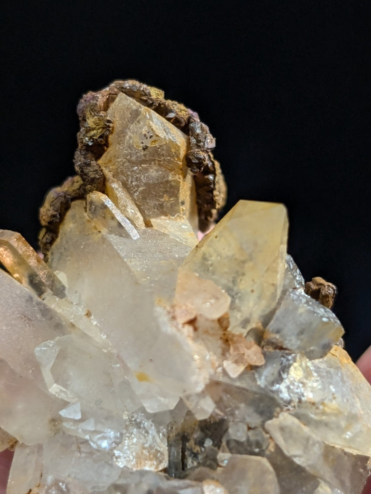 A cluster of translucent quartz crystals with golden and milky white hues, some exhibiting a faint amber tint.
