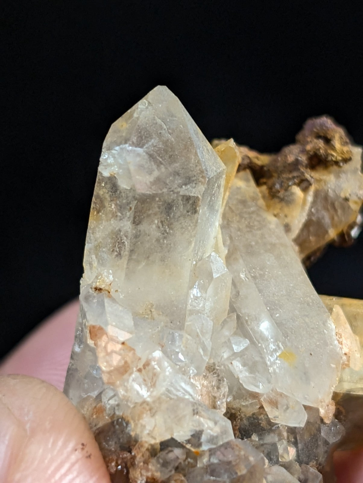 A translucent, clear quartz crystal cluster with sharp facets and subtle internal inclusions.
