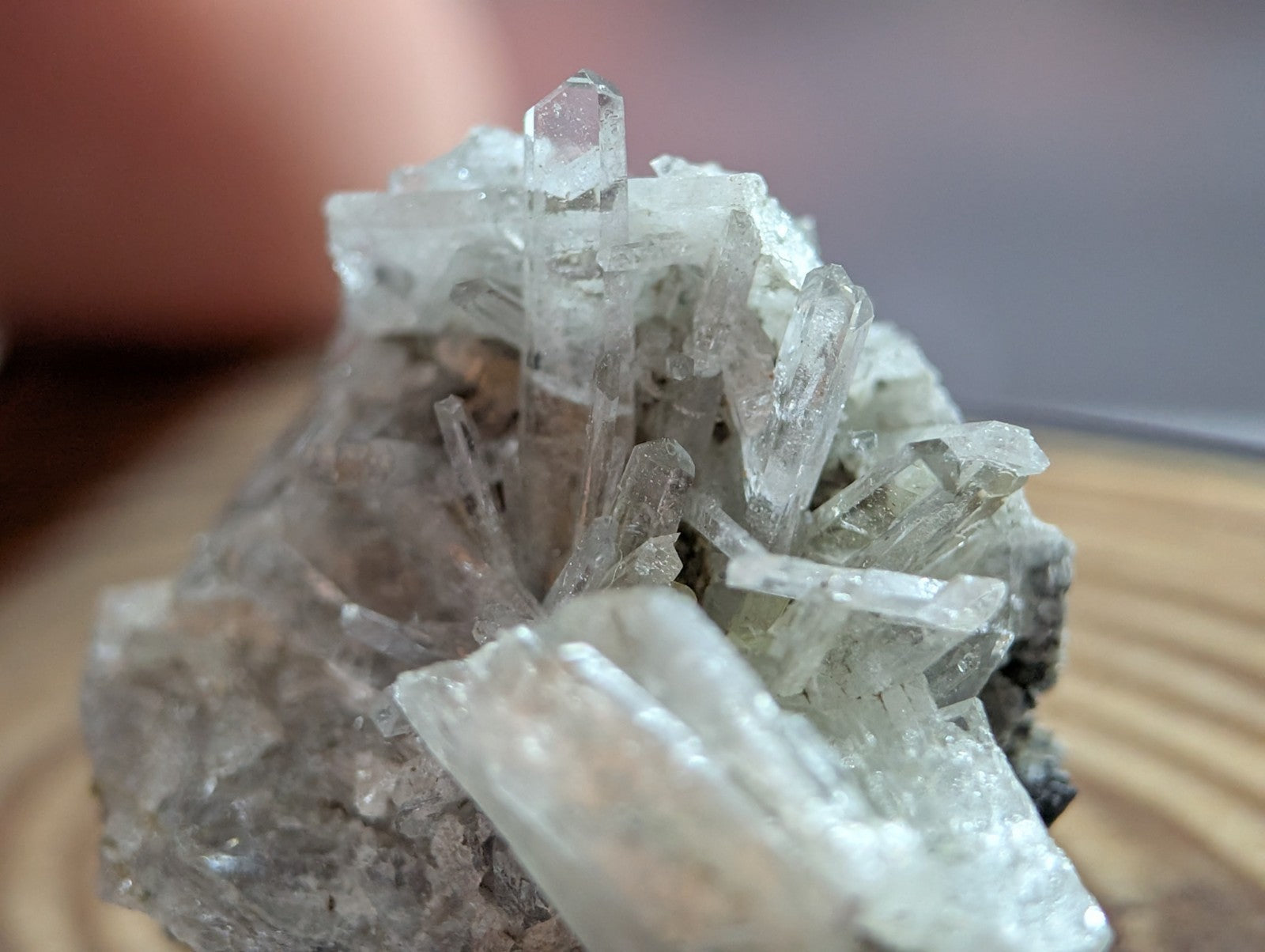 A translucent, crystalline mineral specimen with sharp, angular facets and a pale grayish-white hue.