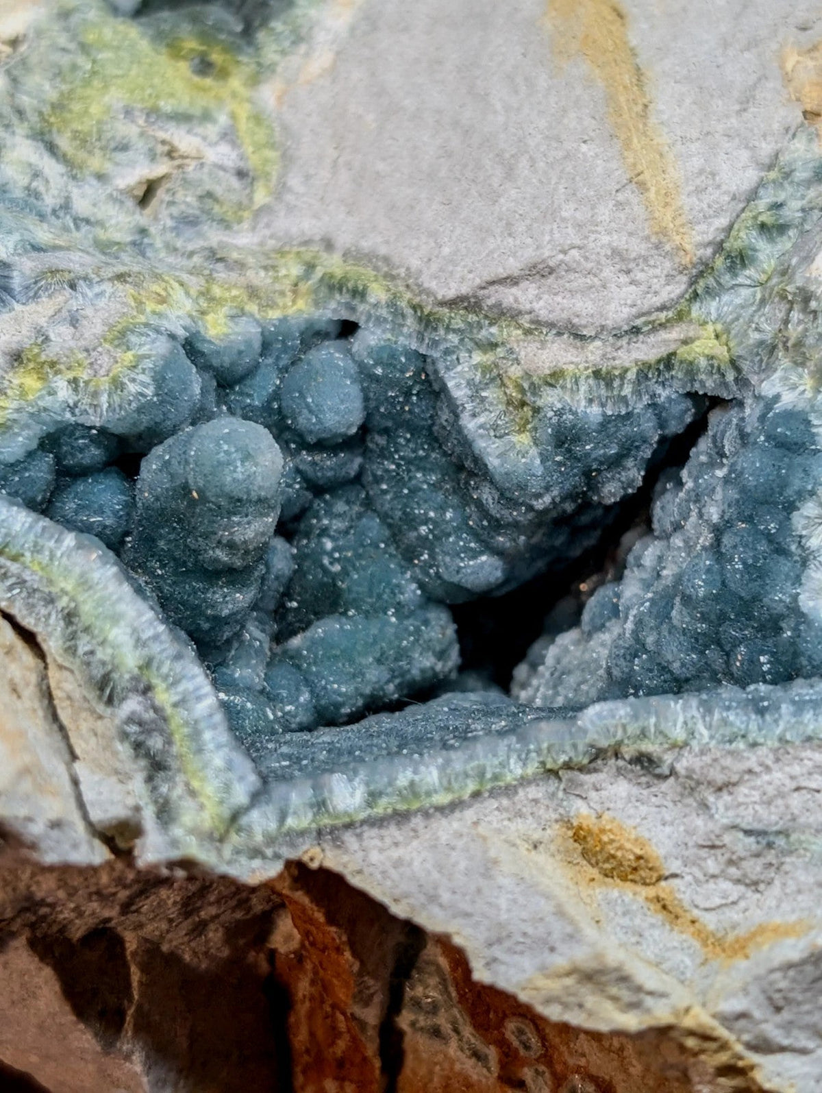 Deep blue, textured mineral formations nestled within a cracked rock matrix.