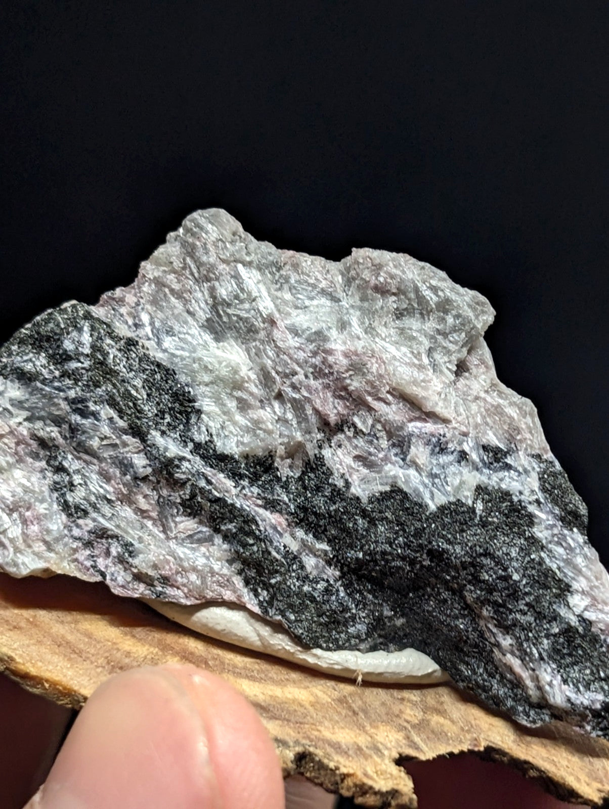 A rugged, naturally occurring mineral specimen with a mottled pattern of gray and black crystalline formations.