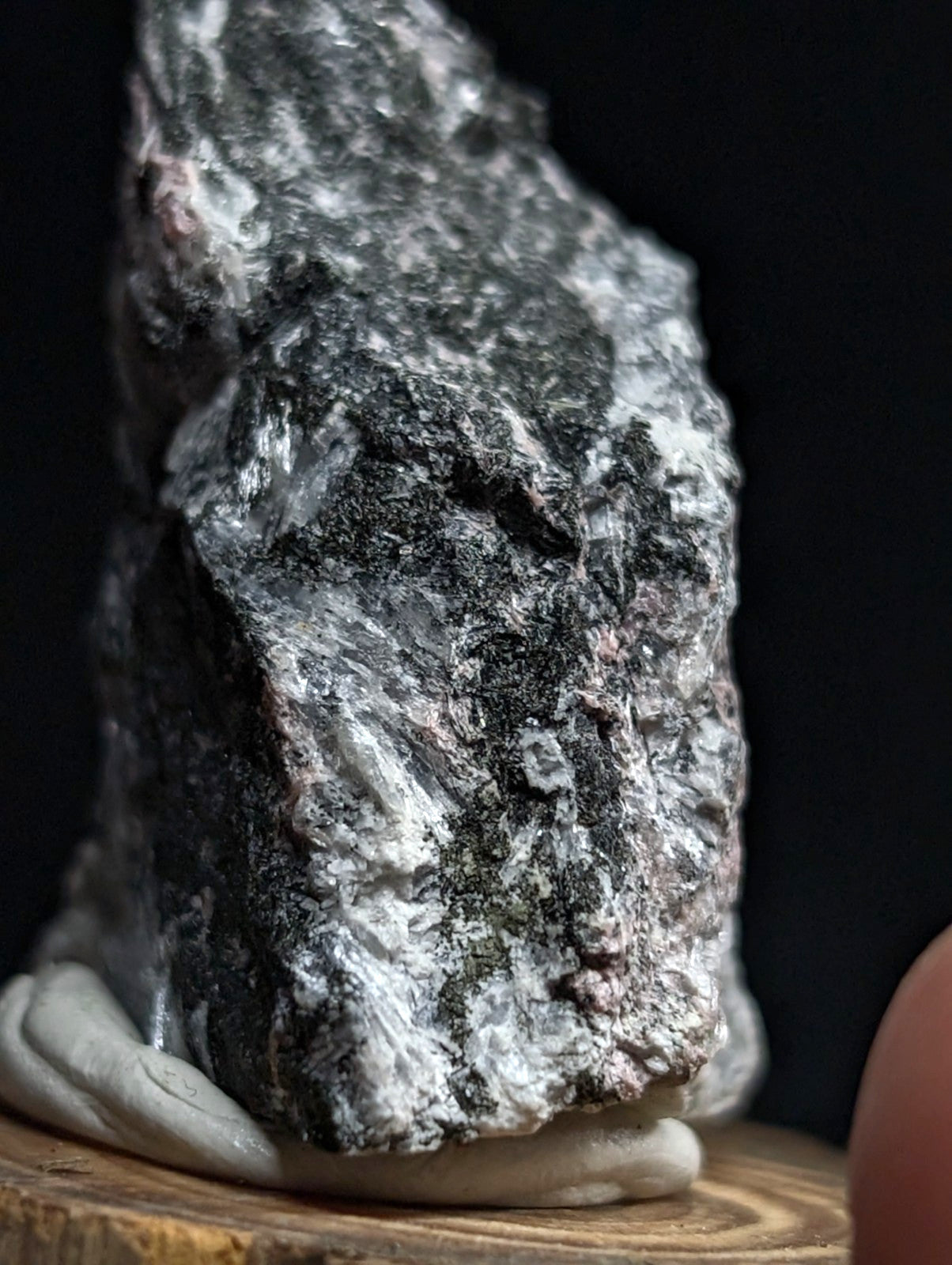 A rugged, naturally occurring mineral specimen with a mottled gray and white surface texture.