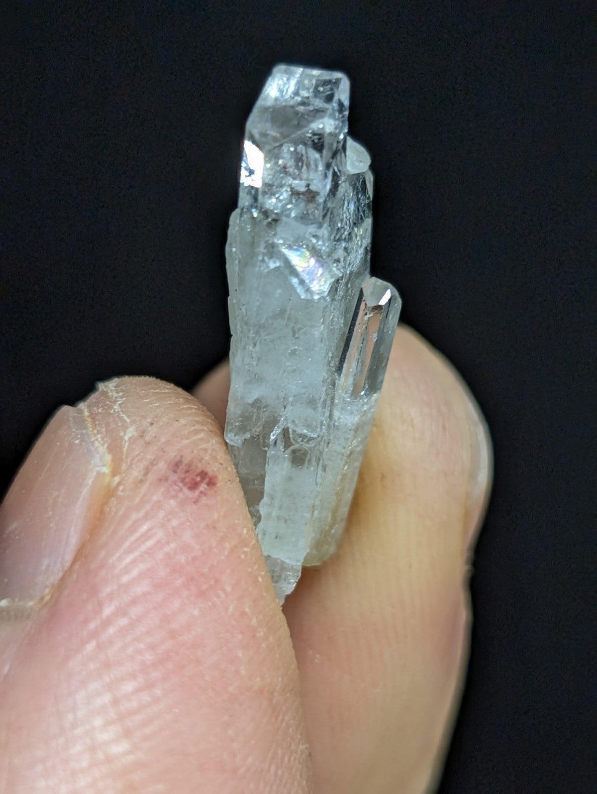 A translucent, pale blue quartz crystal cluster with sharp, faceted edges and a natural, rugged texture.