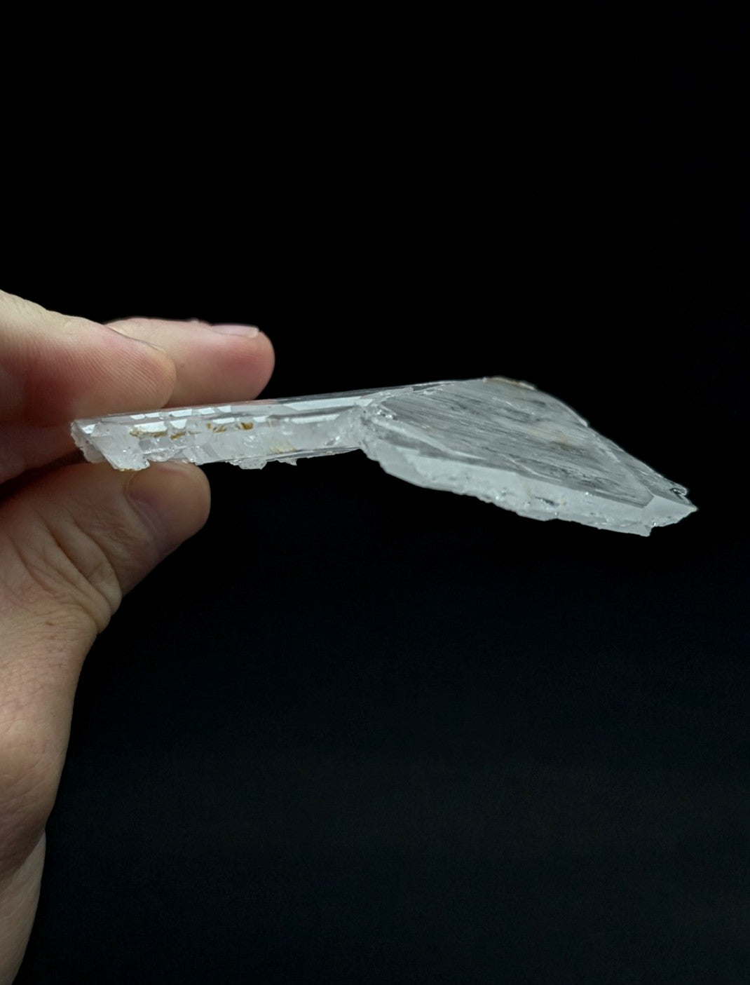A translucent clear quartz crystal fragment with jagged edge and natural striations from garland county arkansas