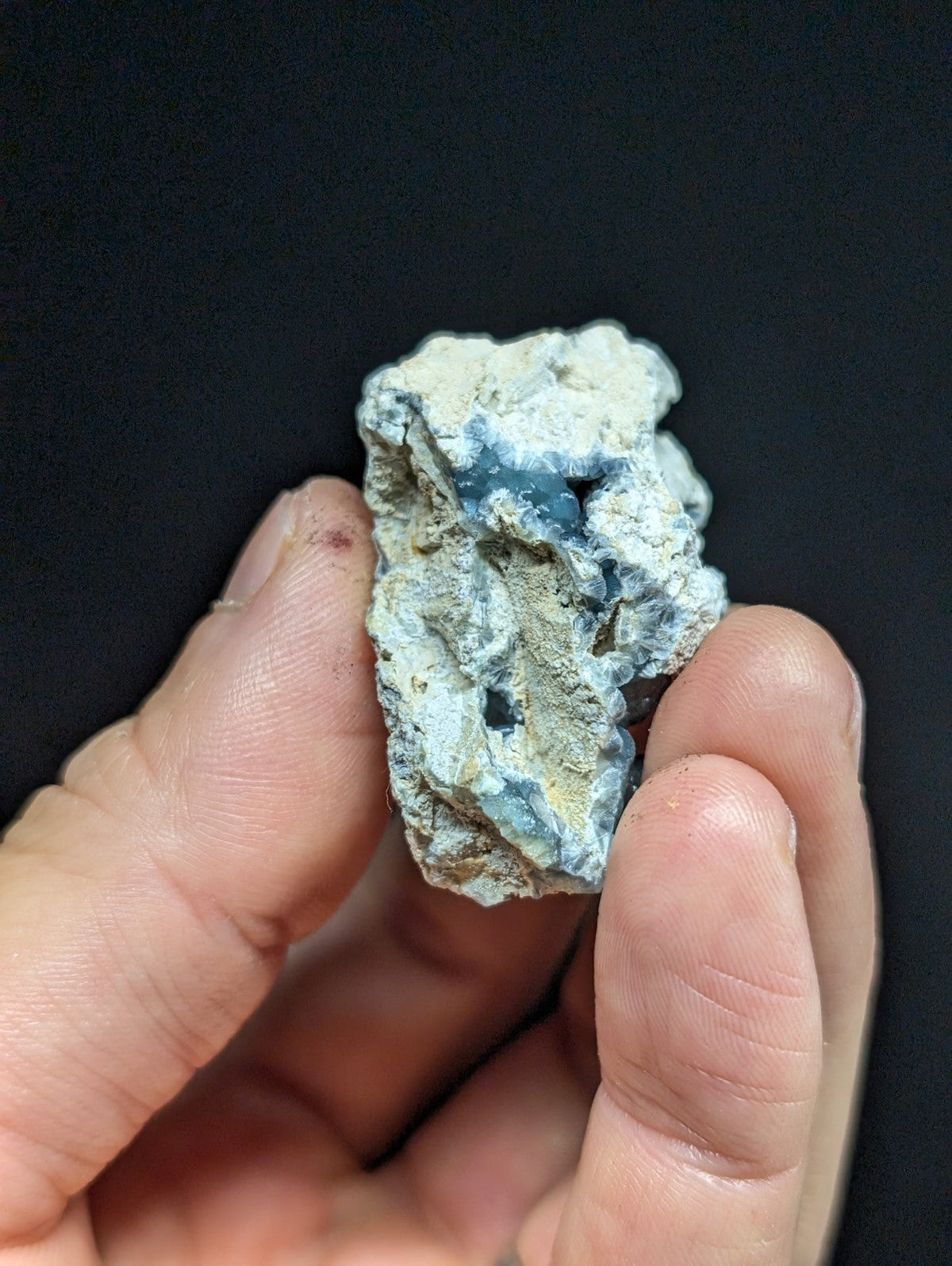 A rough, irregularly shaped piece of blue and white mineral with a textured surface.