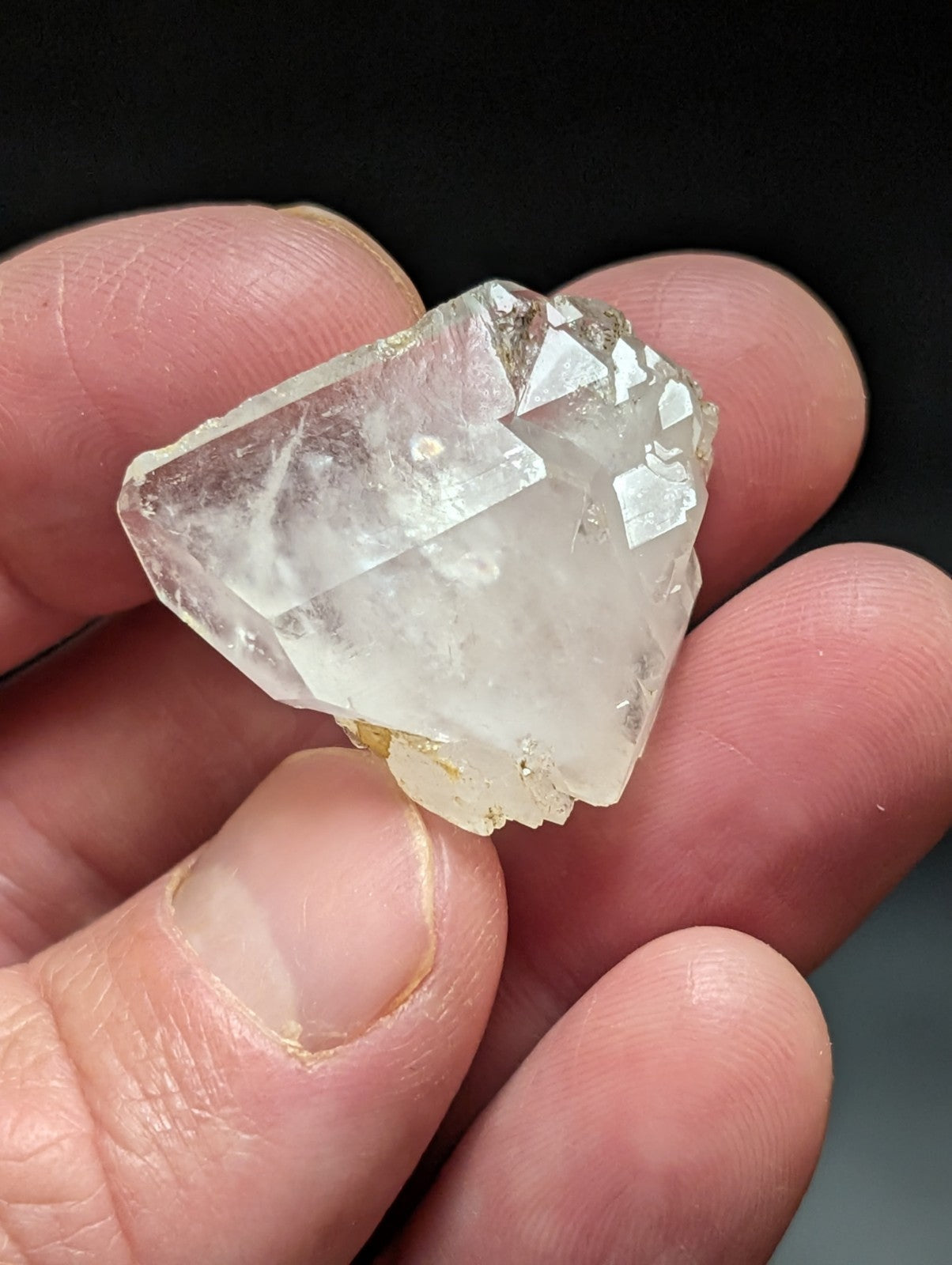 A translucent, faceted quartz crystal with a clear and slightly cloudy appearance.