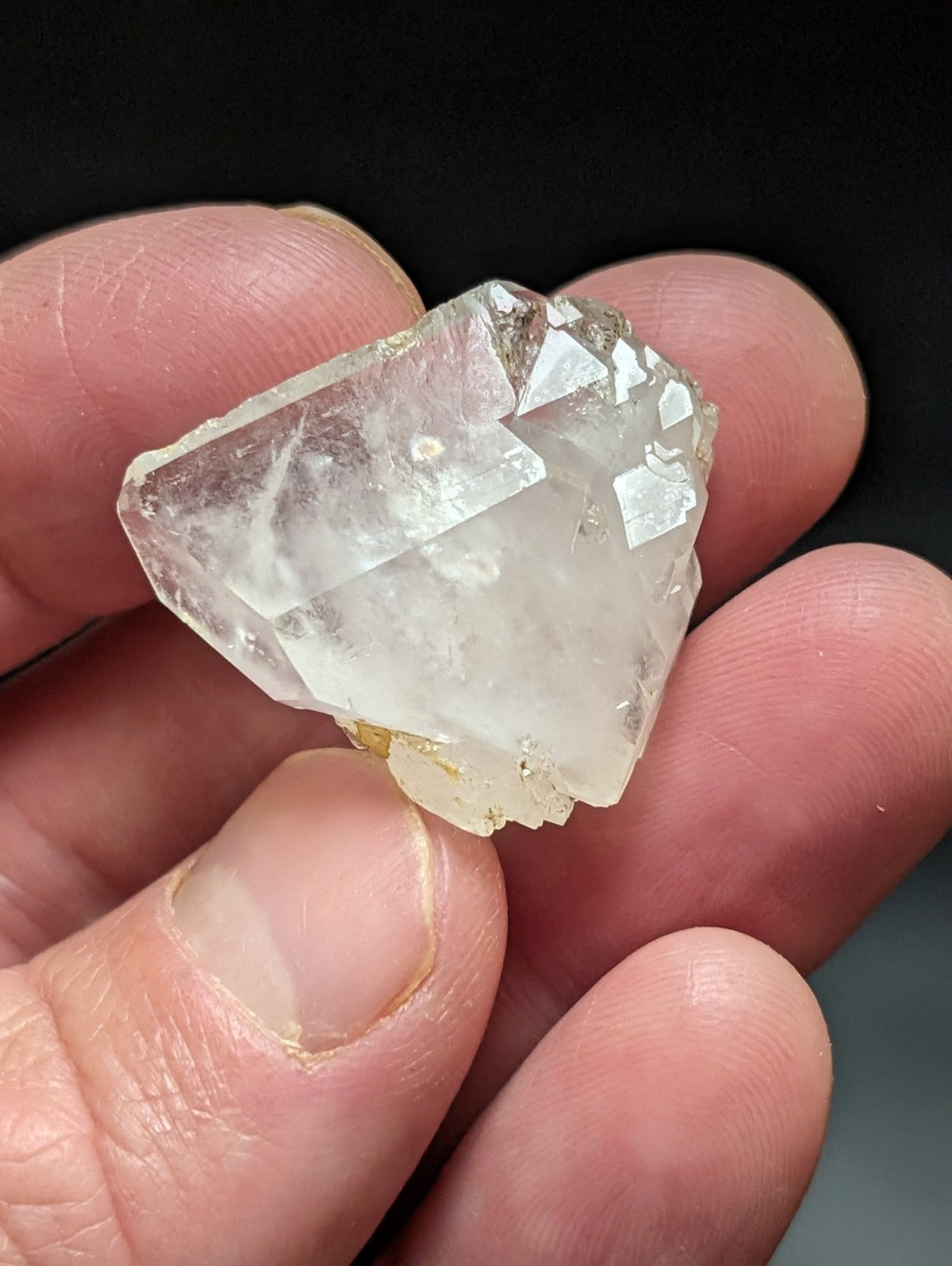 A translucent, faceted quartz crystal with a clear and slightly cloudy appearance.