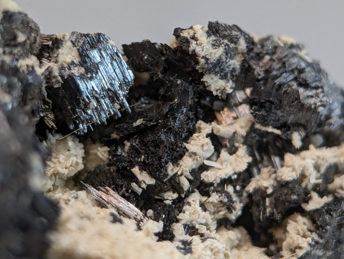 Rutile in matrix featuring a striking black and blue metallic fibrous crystalline cluster from magnet cove arkansas
