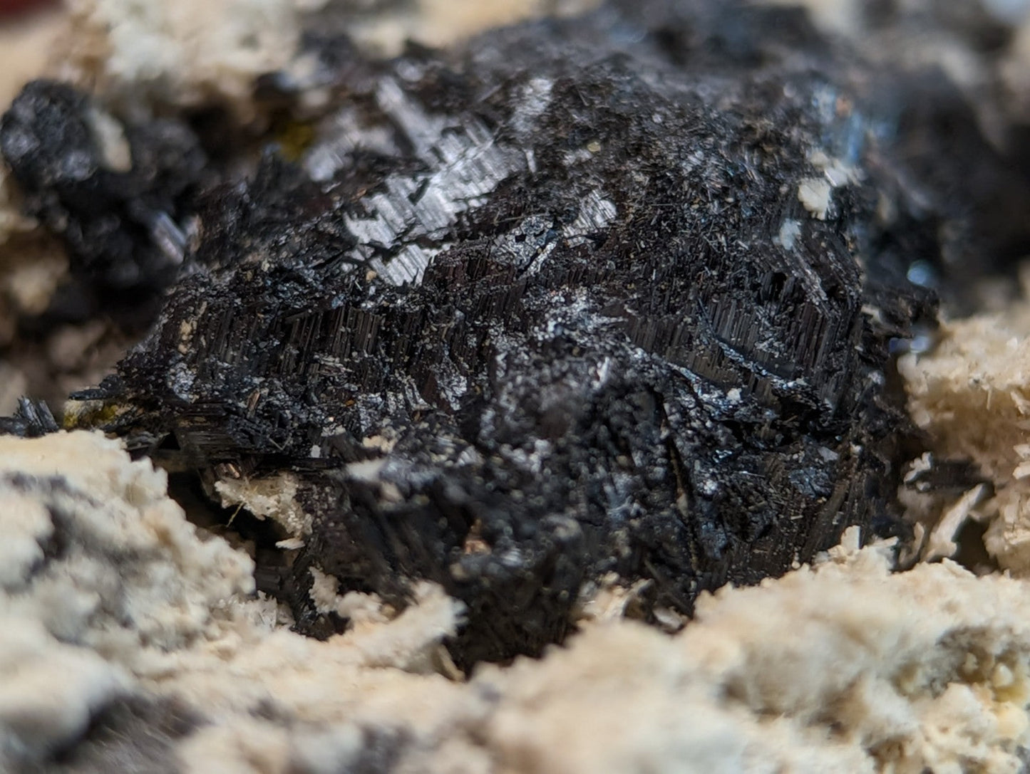 Dark rough-textured rutile in matrix with matte black surface and subtle metallic sheen from magnet cove arkansas