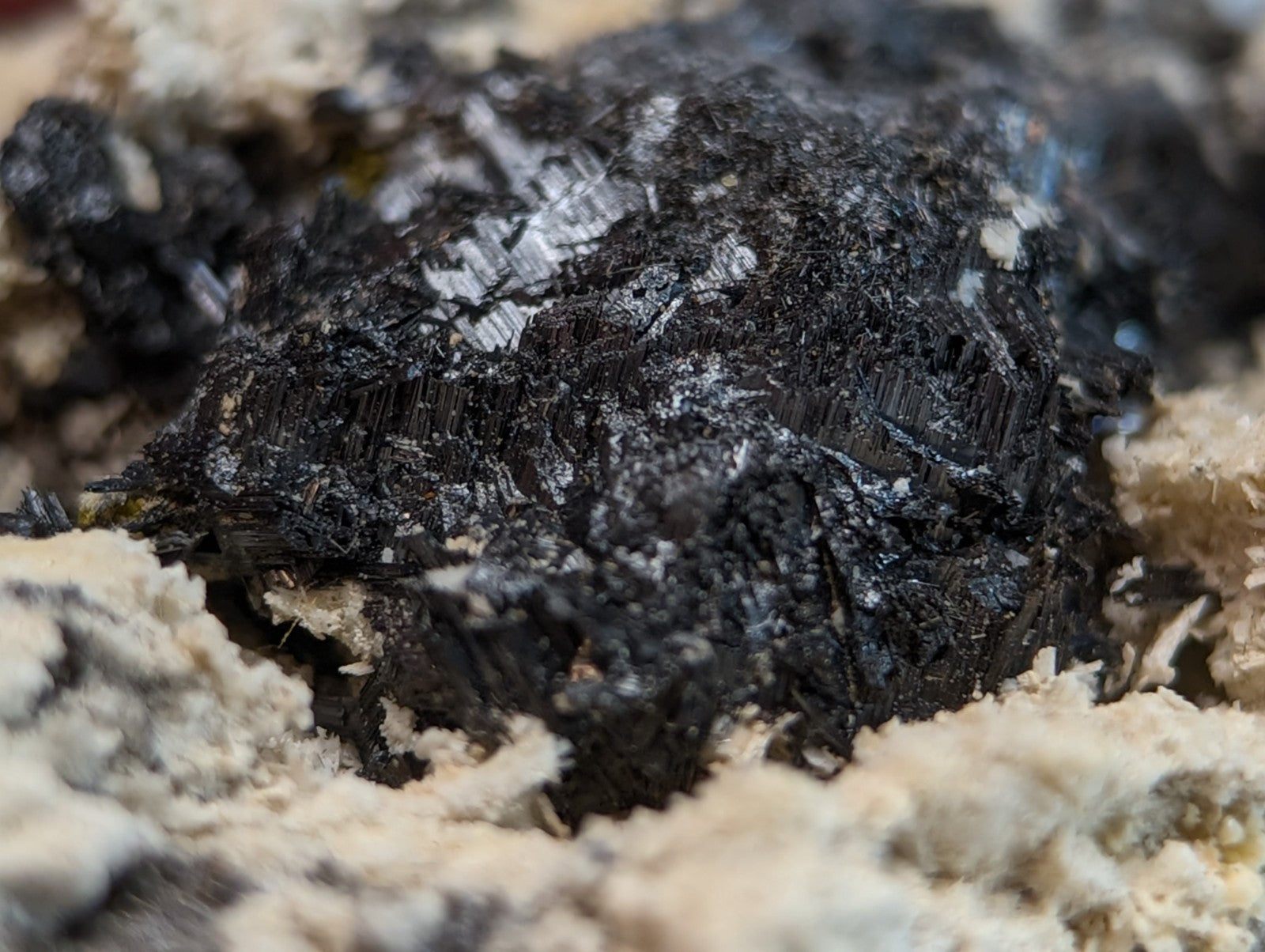 Dark rough-textured rutile in matrix with matte black surface and subtle metallic sheen from magnet cove arkansas