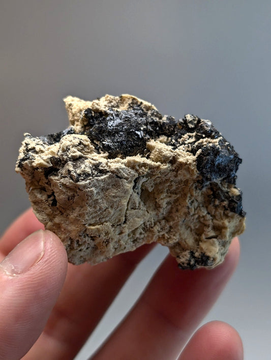 Rutile in matrix mineral specimen from magnet cove arkansas with beige base and black inclusions beautiful cluster